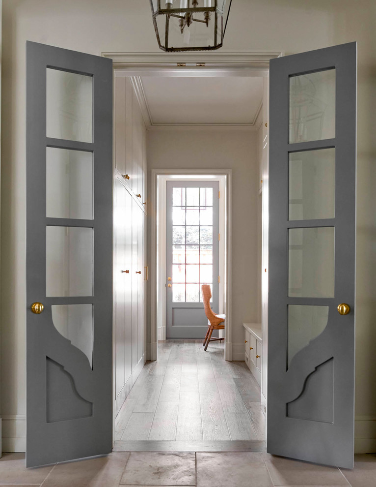 Hallway - mid-sized transitional medium tone wood floor hallway idea in Dallas with white walls