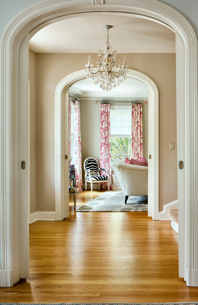 Hallway - transitional medium tone wood floor and yellow floor hallway idea in Austin with beige walls
