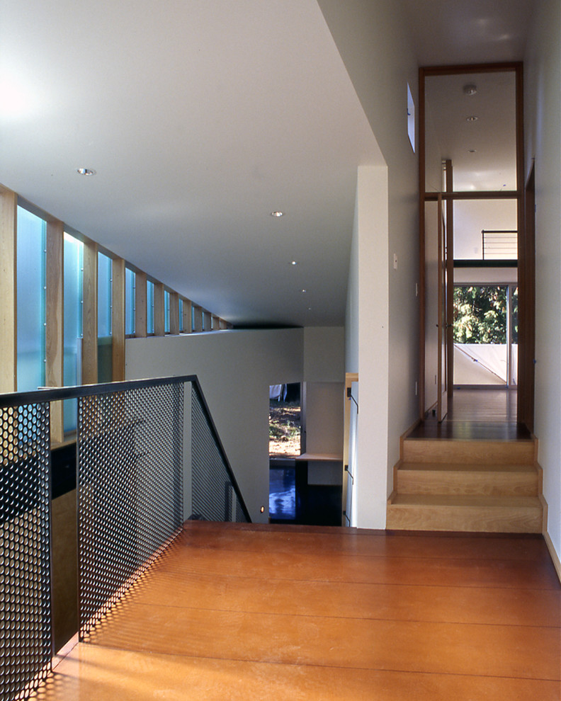 Example of a trendy concrete floor hallway design in Seattle with white walls