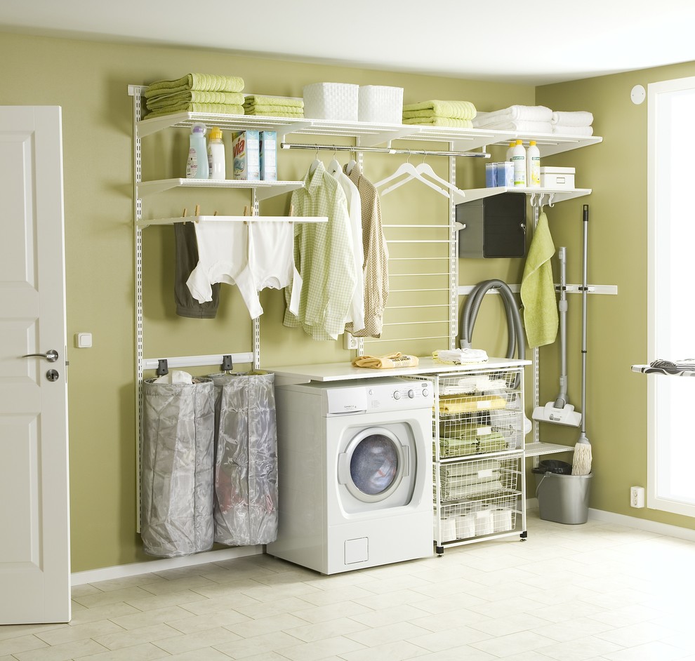 Modern inredning av en stor linjär tvättstuga enbart för tvätt, med öppna hyllor och gröna väggar