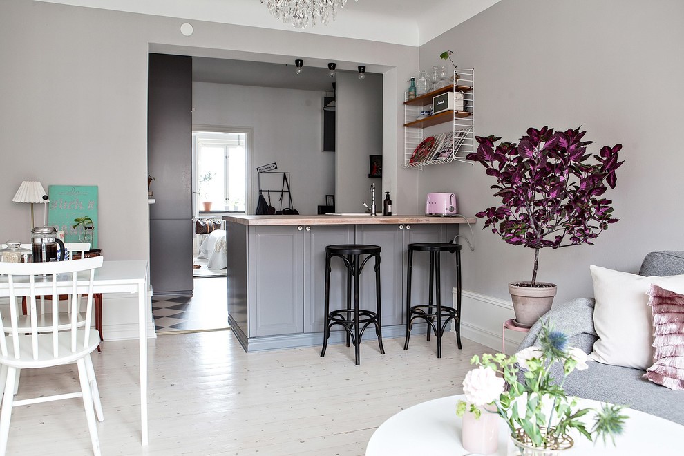 Inspiration for a small scandinavian breakfast bar in Malmo with light hardwood flooring, raised-panel cabinets, grey cabinets and wood worktops.