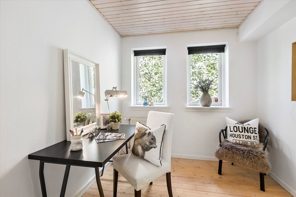 Inspiration for a mid-sized scandinavian freestanding desk light wood floor and beige floor home office remodel in Copenhagen with white walls