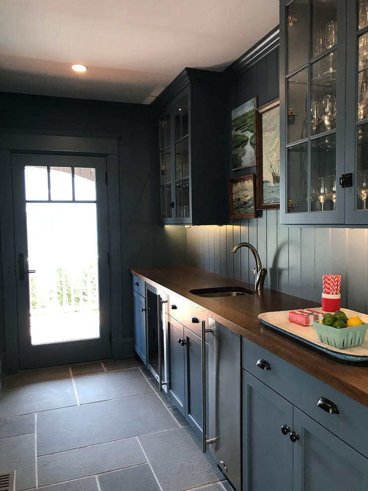 Inspiration for a medium sized beach style galley wet bar in Other with a submerged sink, shaker cabinets, blue cabinets, wood worktops, blue splashback, wood splashback, slate flooring and grey floors.