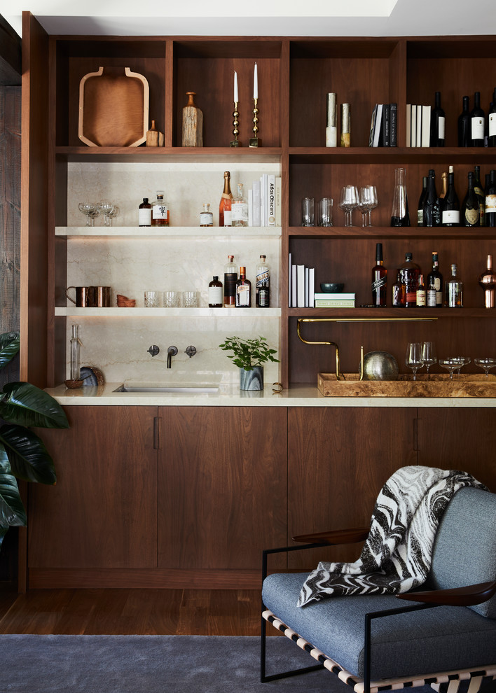 Wet bar - contemporary single-wall dark wood floor and brown floor wet bar idea in San Francisco with an undermount sink, flat-panel cabinets, dark wood cabinets, white backsplash and white countertops