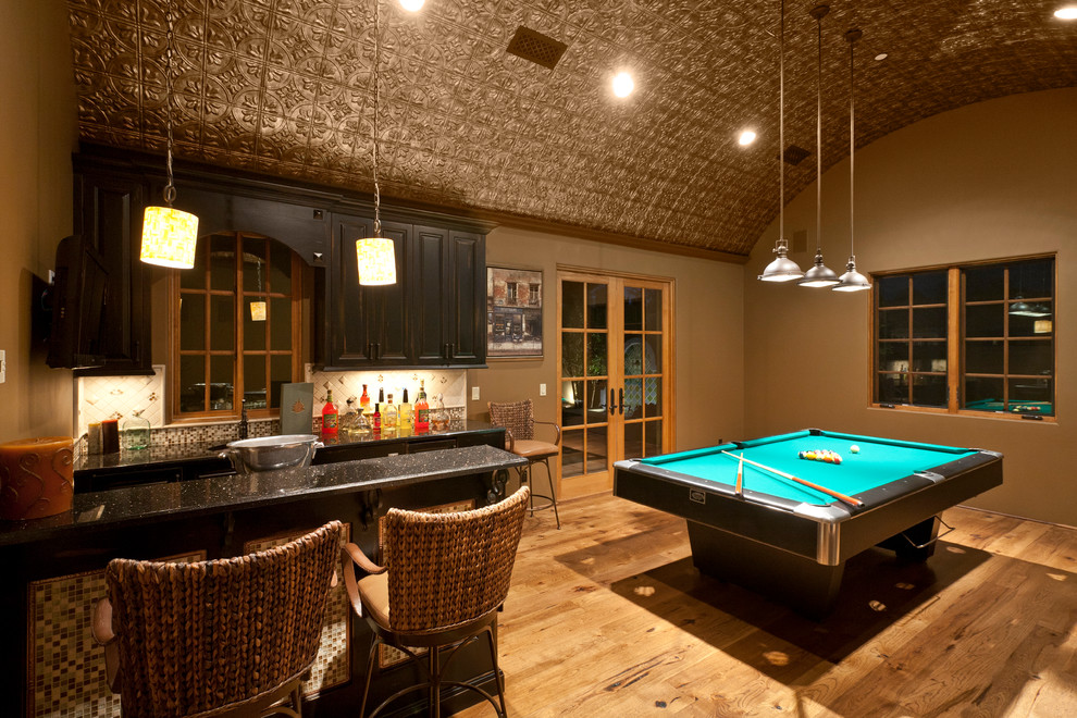 Example of a tuscan brown floor home bar design in Phoenix