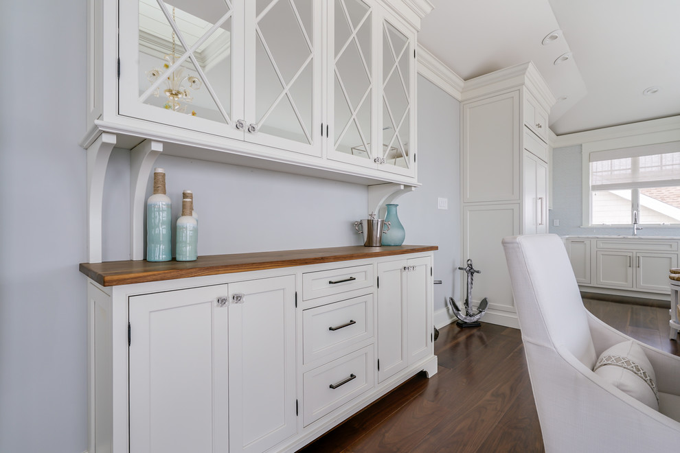Inspiration for a mid-sized farmhouse single-wall dark wood floor and brown floor wet bar remodel in Philadelphia with recessed-panel cabinets, white cabinets, white backsplash, no sink and wood countertops