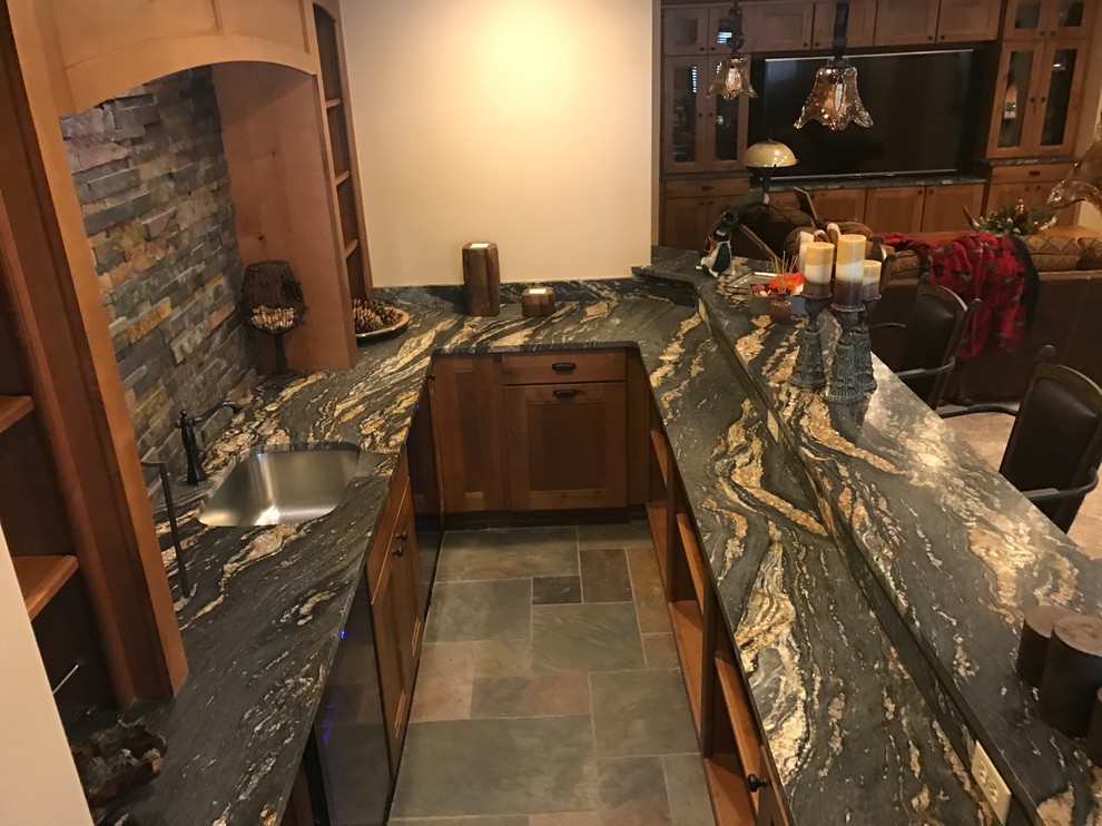 Inspiration for a large rustic single-wall slate floor and multicolored floor seated home bar remodel in Other with an undermount sink, open cabinets, medium tone wood cabinets, granite countertops, multicolored backsplash and stone tile backsplash