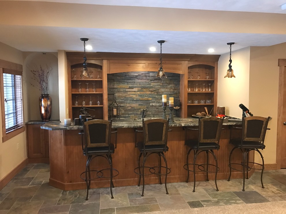 Seated home bar - large rustic single-wall slate floor and multicolored floor seated home bar idea in Other with an undermount sink, open cabinets, medium tone wood cabinets, granite countertops, multicolored backsplash and stone tile backsplash