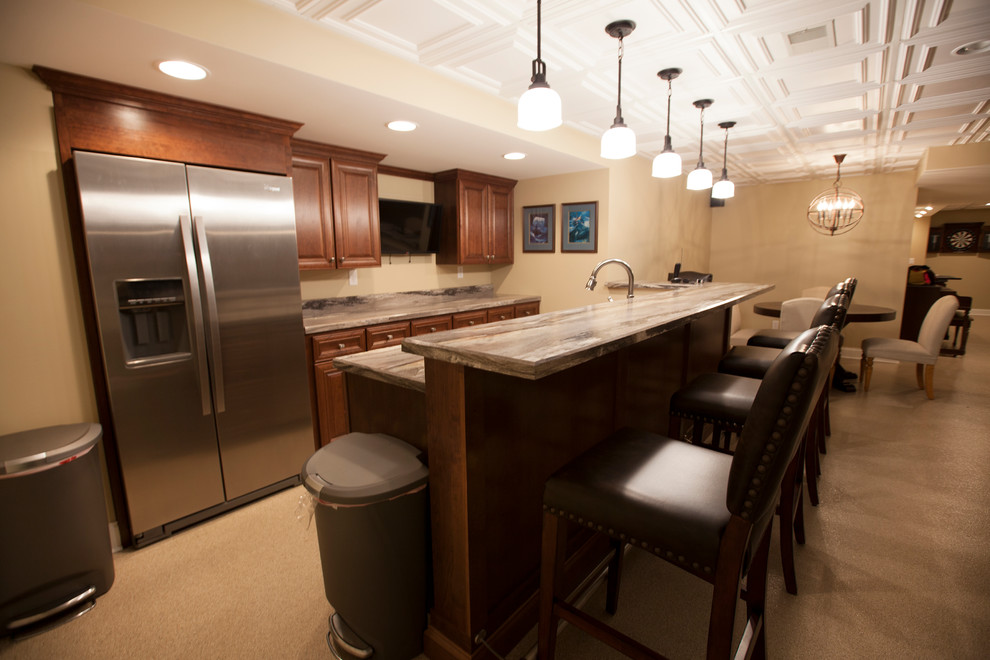 This is an example of a medium sized classic galley home bar in Chicago with raised-panel cabinets, medium wood cabinets and granite worktops.
