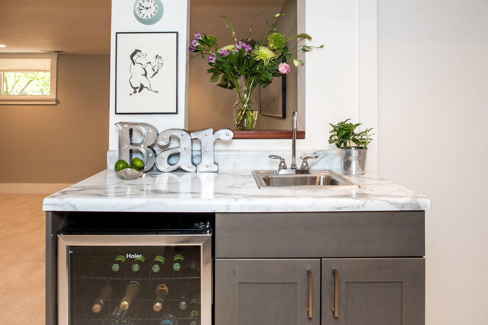 Trendy wet bar photo in Seattle with a drop-in sink, shaker cabinets, gray cabinets and laminate countertops