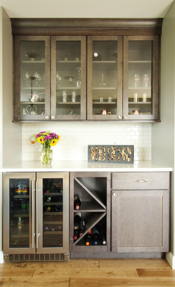 Small single-wall home bar in Other with medium hardwood flooring.