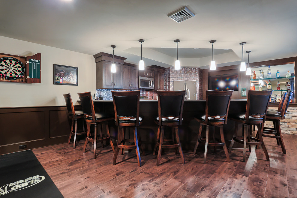 Example of a huge classic u-shaped carpeted home bar design in Other with medium tone wood cabinets