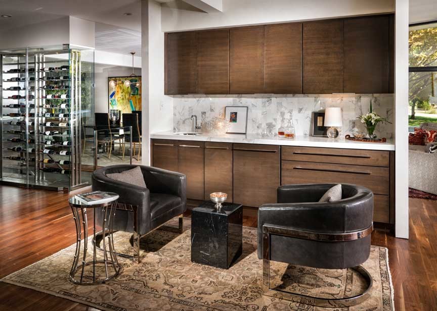 Mid-sized 1960s single-wall medium tone wood floor wet bar photo in Other with an undermount sink, flat-panel cabinets, medium tone wood cabinets, marble countertops, white backsplash and stone tile backsplash