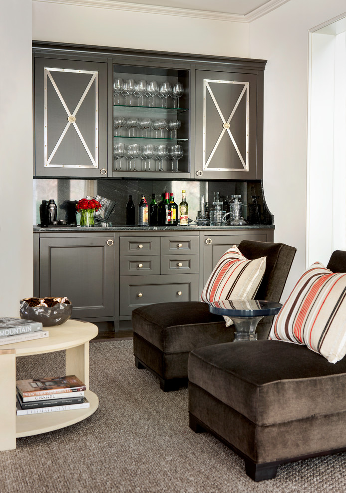 Diseño de bar en casa con barra de bar lineal clásico renovado con armarios con paneles empotrados, puertas de armario marrones, salpicadero negro y salpicadero de mármol