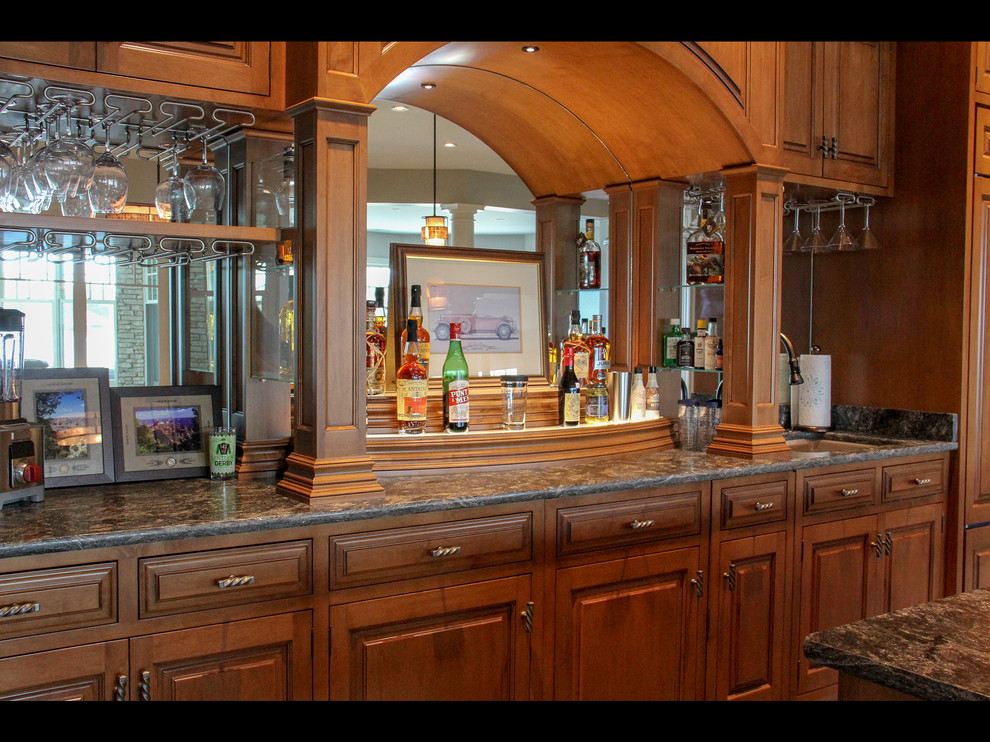Inspiration for a large coastal galley slate floor and gray floor seated home bar remodel in Other with an undermount sink, recessed-panel cabinets, medium tone wood cabinets and black countertops