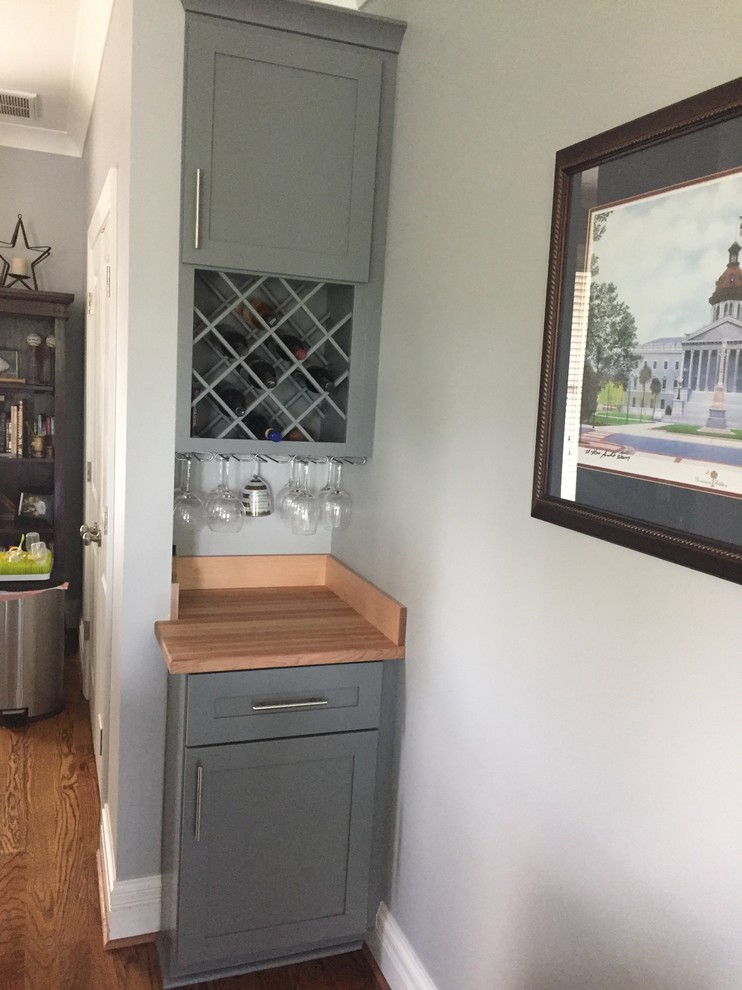 Photo of a small classic single-wall wet bar in Other with shaker cabinets, grey cabinets, wood worktops, medium hardwood flooring and brown floors.