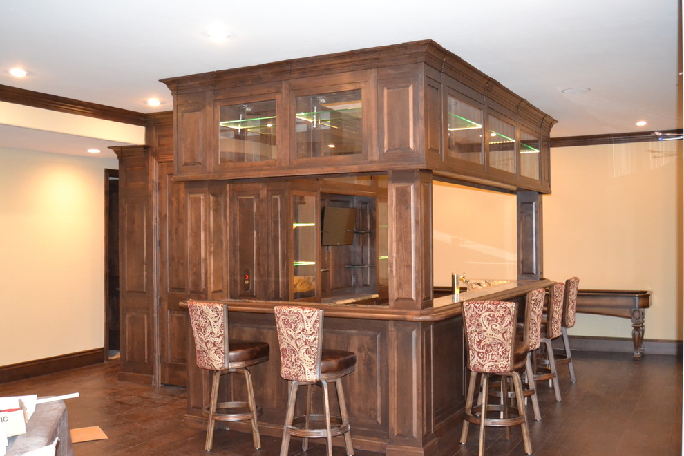 Photo of an expansive rustic l-shaped breakfast bar in Denver with raised-panel cabinets, medium wood cabinets, granite worktops, multi-coloured splashback, stone slab splashback and medium hardwood flooring.