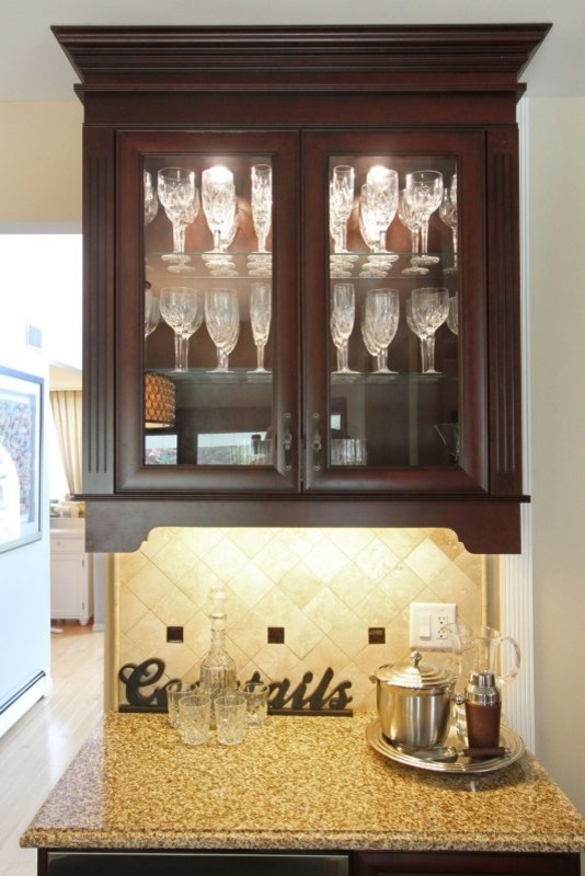 Inspiration for a mid-sized timeless galley marble floor home bar remodel in New York with raised-panel cabinets, white cabinets, granite countertops and beige backsplash