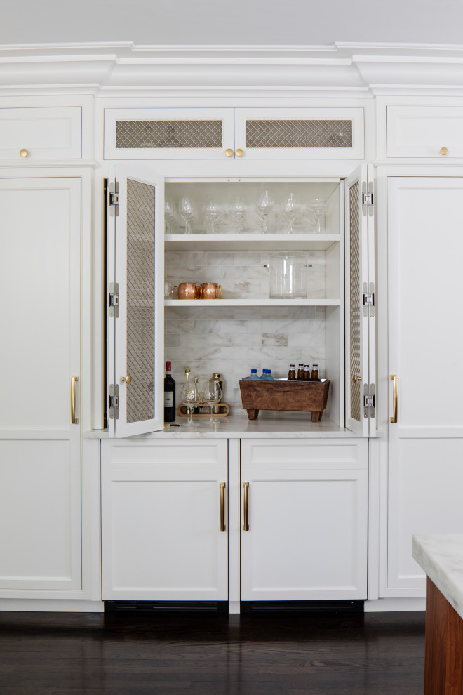 Design ideas for a traditional single-wall dry bar in Boston with recessed-panel cabinets, white cabinets, white splashback, dark hardwood flooring, brown floors and white worktops.