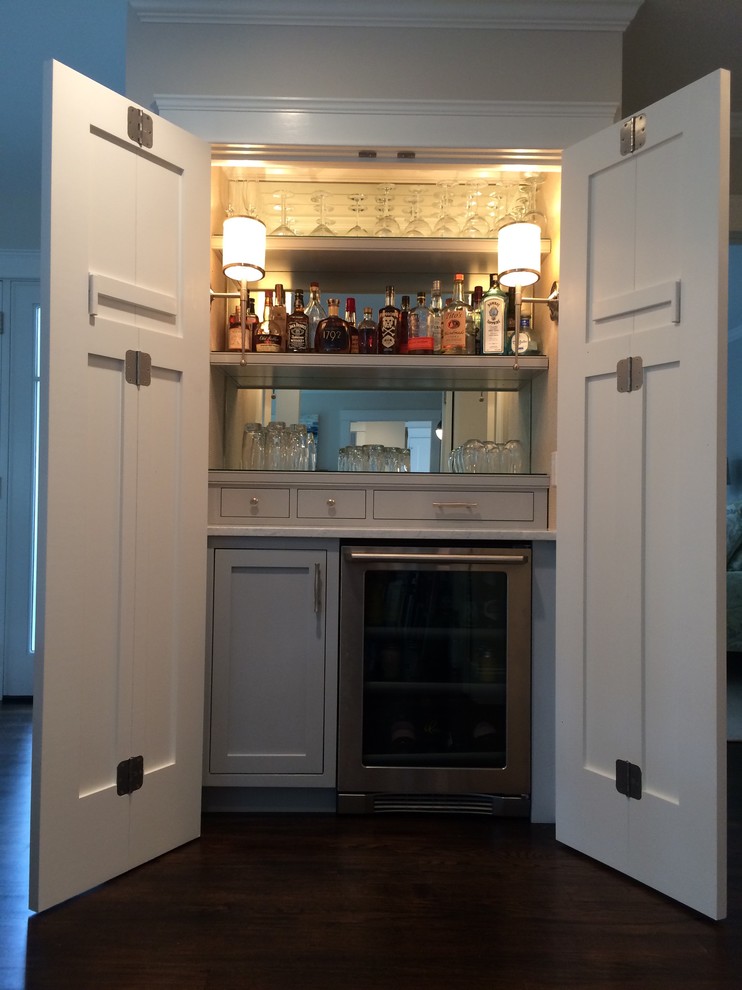 This is an example of a small classic galley home bar in New York with shaker cabinets, grey cabinets, marble worktops and medium hardwood flooring.