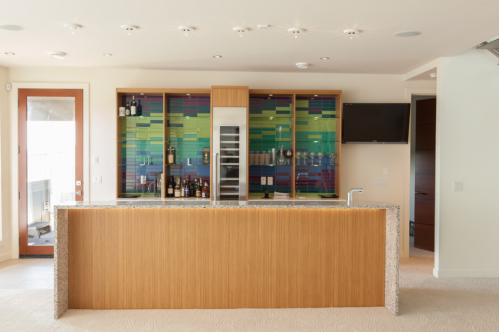 Inspiration for a medium sized contemporary galley wet bar in Edmonton with open cabinets, medium wood cabinets, multi-coloured splashback and carpet.