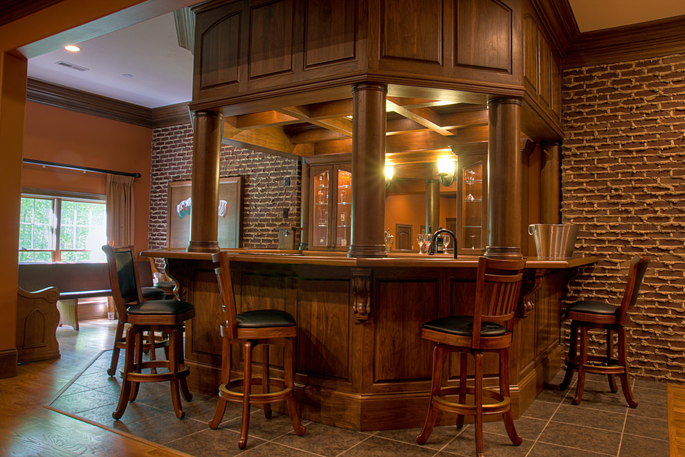 Foto di un bancone bar classico di medie dimensioni con ante di vetro, top in legno, paraspruzzi rosso, paraspruzzi in mattoni, pavimento marrone e ante in legno scuro