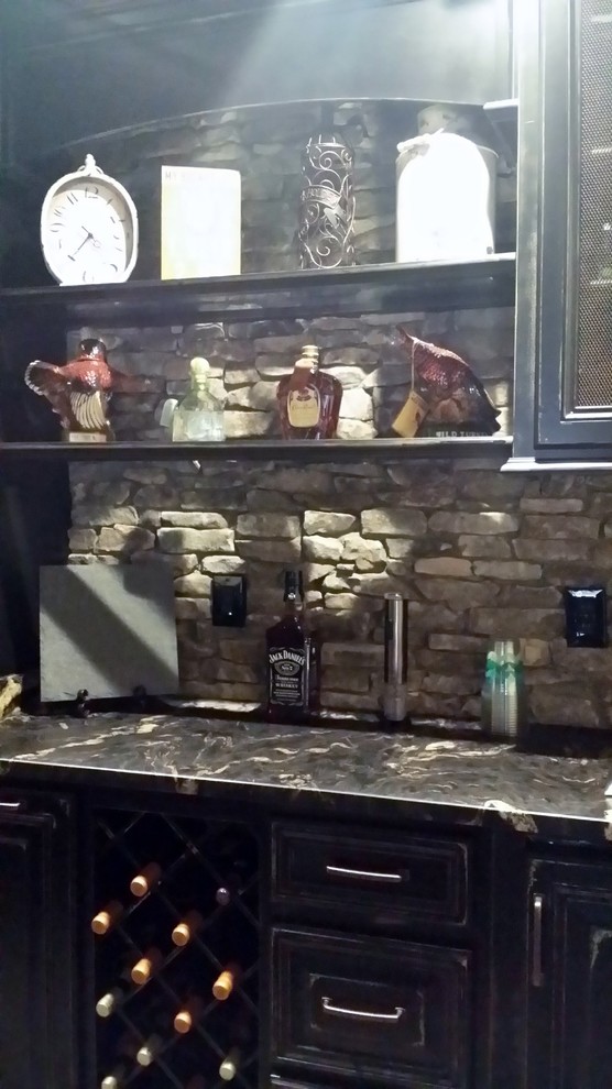 Photo of a small rustic galley wet bar in Atlanta with a built-in sink, raised-panel cabinets, distressed cabinets, quartz worktops, grey splashback, stone slab splashback, ceramic flooring, orange floors and multicoloured worktops.