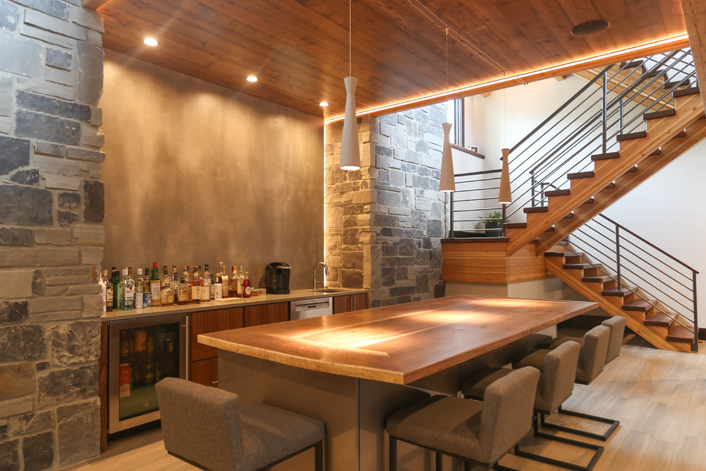 This is an example of a large contemporary galley breakfast bar in Other with a submerged sink, flat-panel cabinets, medium wood cabinets, wood worktops, grey splashback, porcelain flooring and beige floors.