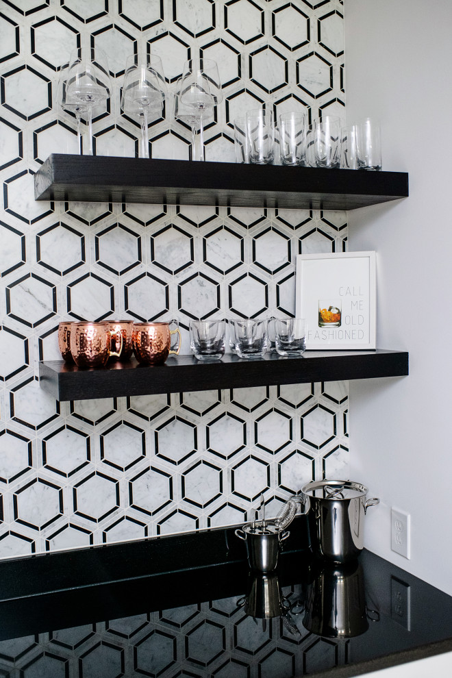 This is an example of a contemporary single-wall wet bar in Cincinnati with a submerged sink, floating shelves, white cabinets, granite worktops, multi-coloured splashback, marble splashback, carpet, grey floors and black worktops.