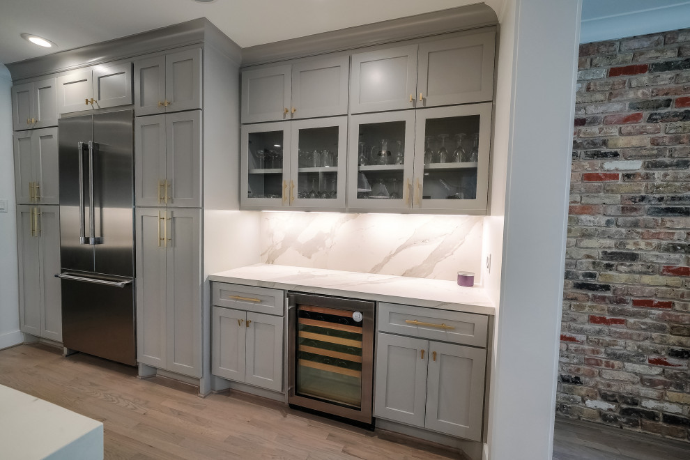 This is an example of a medium sized classic single-wall wet bar in Houston with shaker cabinets, grey cabinets, composite countertops, beige splashback, stone slab splashback, porcelain flooring, grey floors and white worktops.
