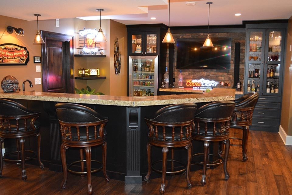 Example of a mountain style home bar design in Calgary