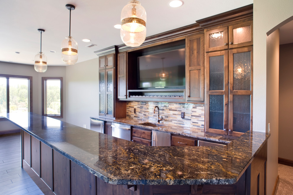 Photo of a traditional u-shaped breakfast bar in Other with a submerged sink, raised-panel cabinets, brown cabinets, granite worktops, multi-coloured splashback, glass tiled splashback, laminate floors and brown floors.
