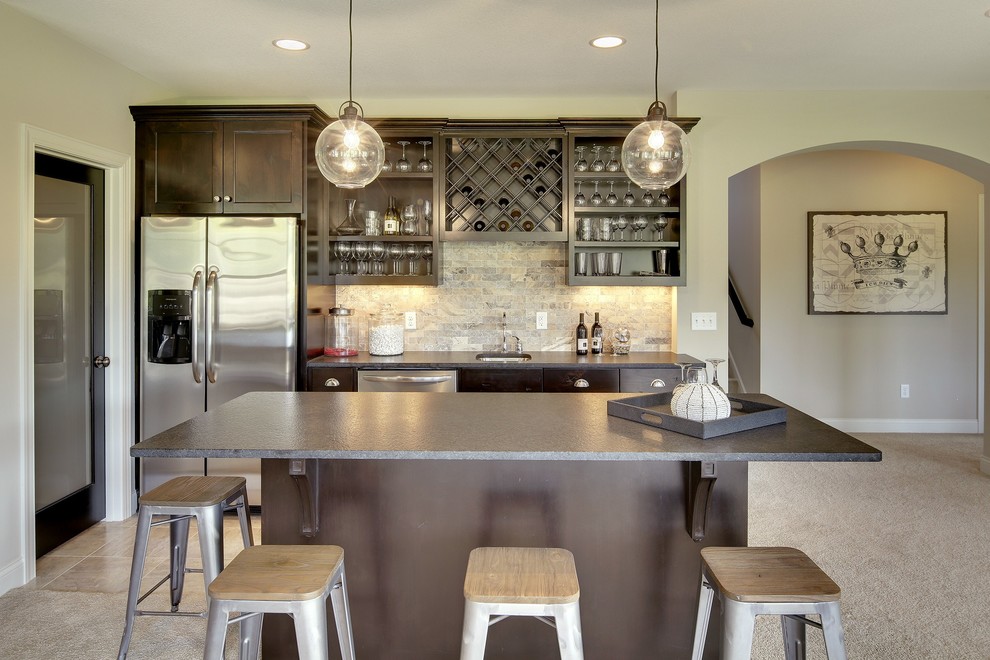 Inspiration for a large transitional ceramic tile seated home bar remodel in Minneapolis with an undermount sink, recessed-panel cabinets, dark wood cabinets, quartz countertops, gray backsplash and travertine backsplash