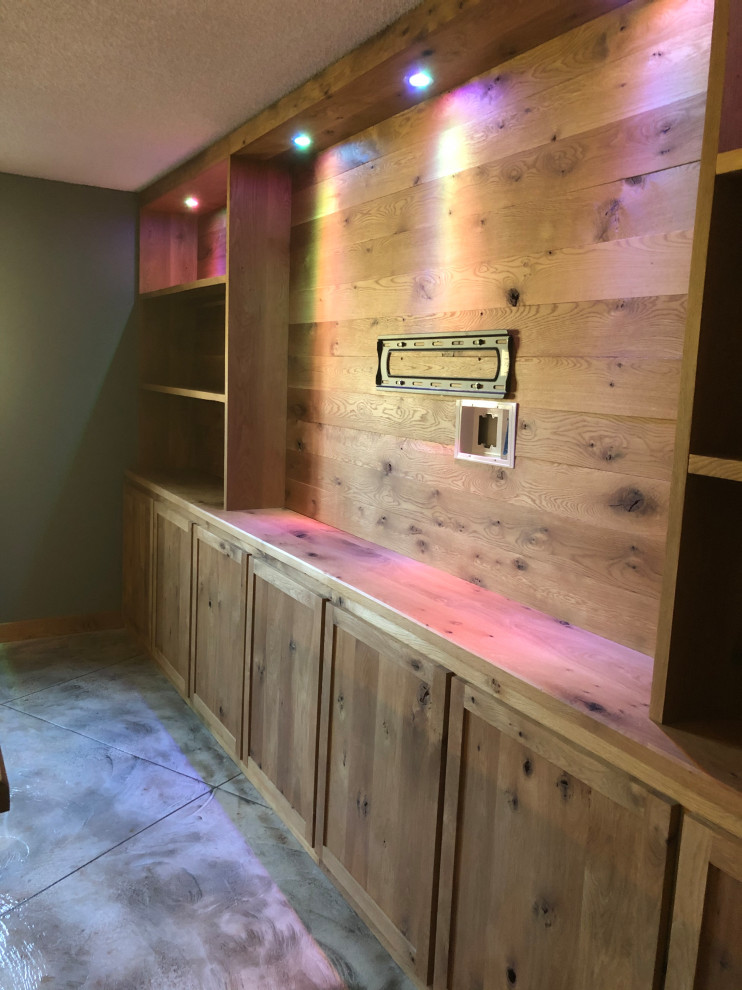 Photo of a large rustic l-shaped home bar in Other with shaker cabinets, medium wood cabinets, wood worktops, concrete flooring and multi-coloured floors.