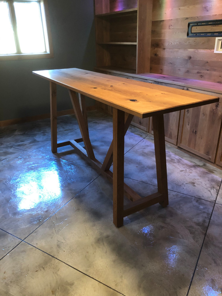 Large rustic l-shaped home bar in Other with shaker cabinets, medium wood cabinets, wood worktops, concrete flooring and multi-coloured floors.