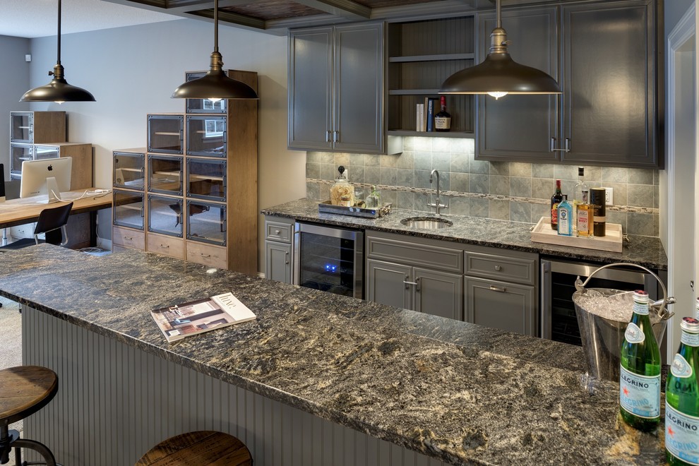 Photo of a large traditional galley breakfast bar in Minneapolis with a submerged sink, recessed-panel cabinets, grey cabinets, marble worktops, grey splashback, stone tiled splashback and ceramic flooring.