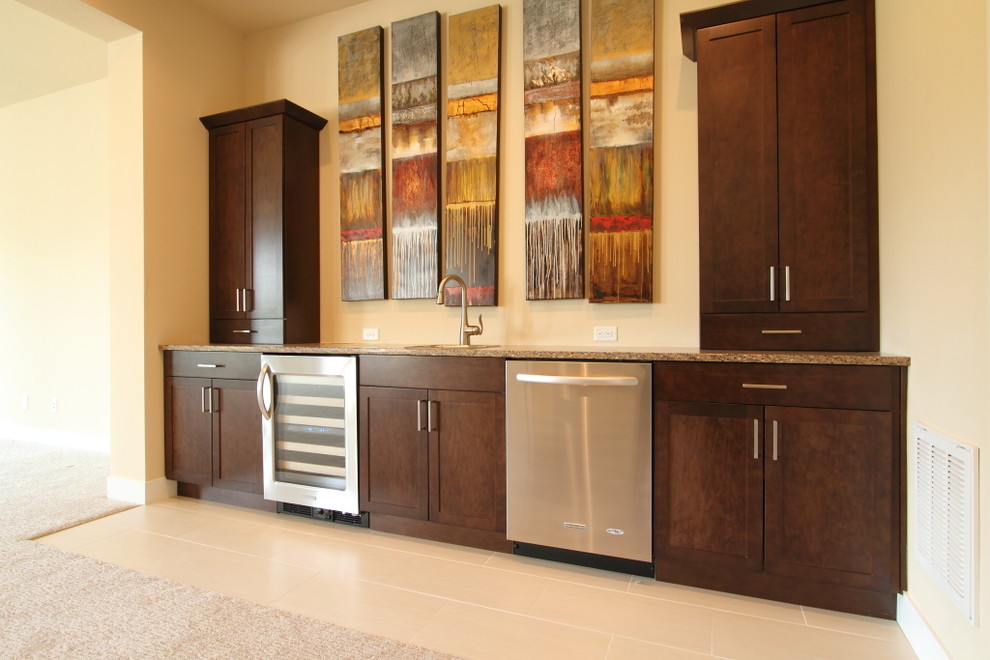 This is an example of a medium sized contemporary single-wall wet bar in Denver with a submerged sink, shaker cabinets, dark wood cabinets, granite worktops and porcelain flooring.