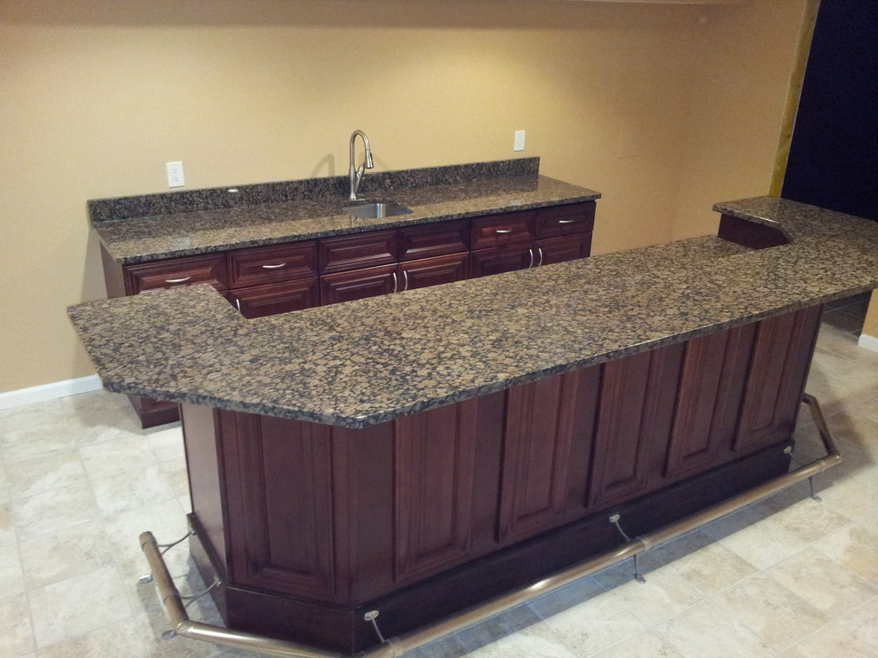 Photo of a large classic single-wall breakfast bar in St Louis with a submerged sink, recessed-panel cabinets, dark wood cabinets, granite worktops and ceramic flooring.