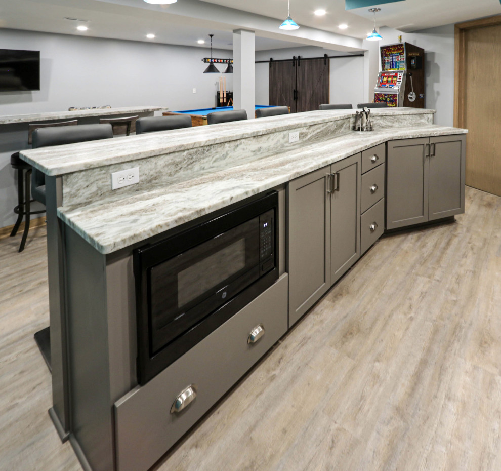 This is an example of a medium sized classic galley breakfast bar with a submerged sink, flat-panel cabinets, grey cabinets, granite worktops, vinyl flooring, brown floors and multicoloured worktops.