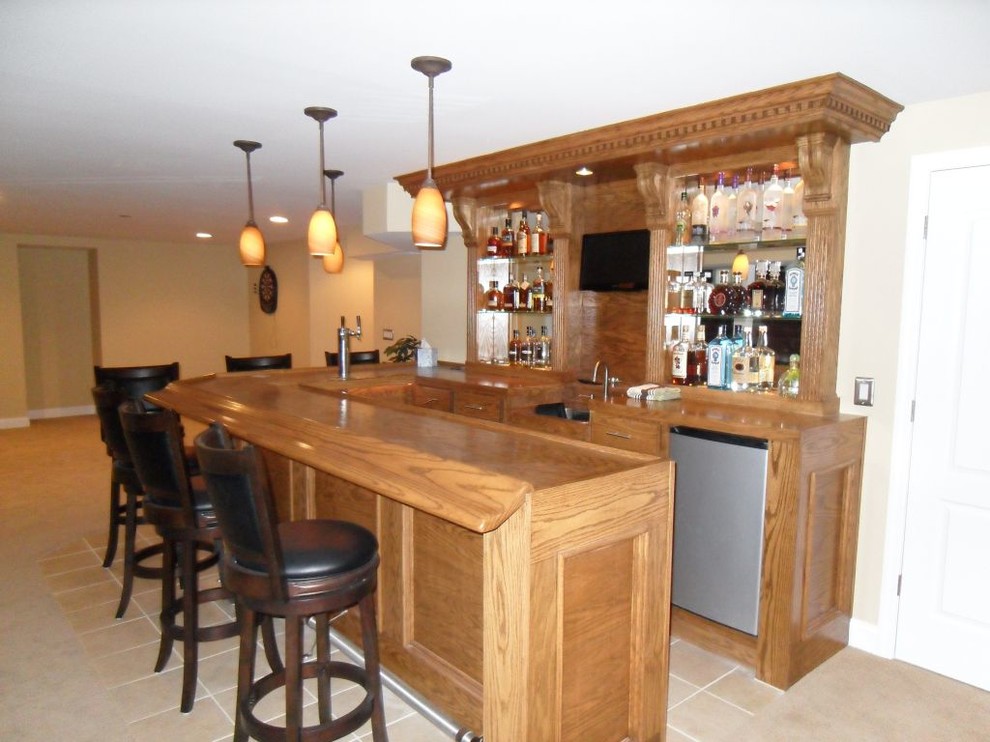 Example of a mid-sized classic porcelain tile seated home bar design in Orange County with wood countertops and brown countertops