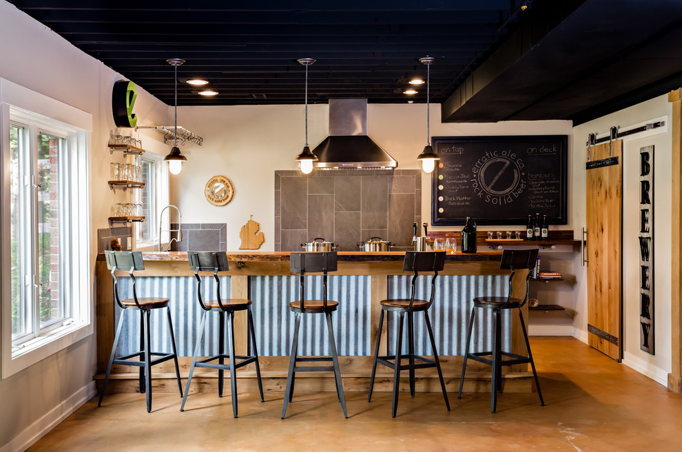 Cette photo montre un bar de salon avec évier industriel avec un plan de travail en bois, une crédence grise et un sol marron.