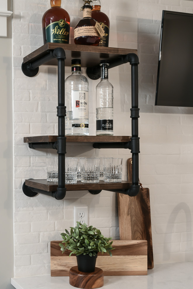 Inspiration for a medium sized traditional home bar in St Louis with a submerged sink, flat-panel cabinets, blue cabinets, engineered stone countertops, white splashback, ceramic splashback, grey floors and white worktops.