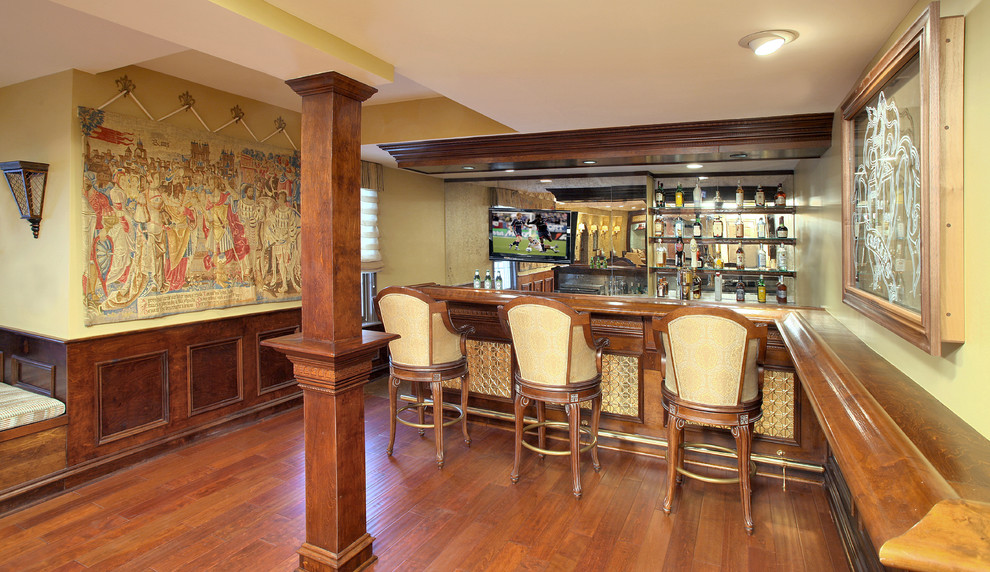 Seated home bar - huge mediterranean l-shaped medium tone wood floor and brown floor seated home bar idea in DC Metro with open cabinets, medium tone wood cabinets, wood countertops and mirror backsplash