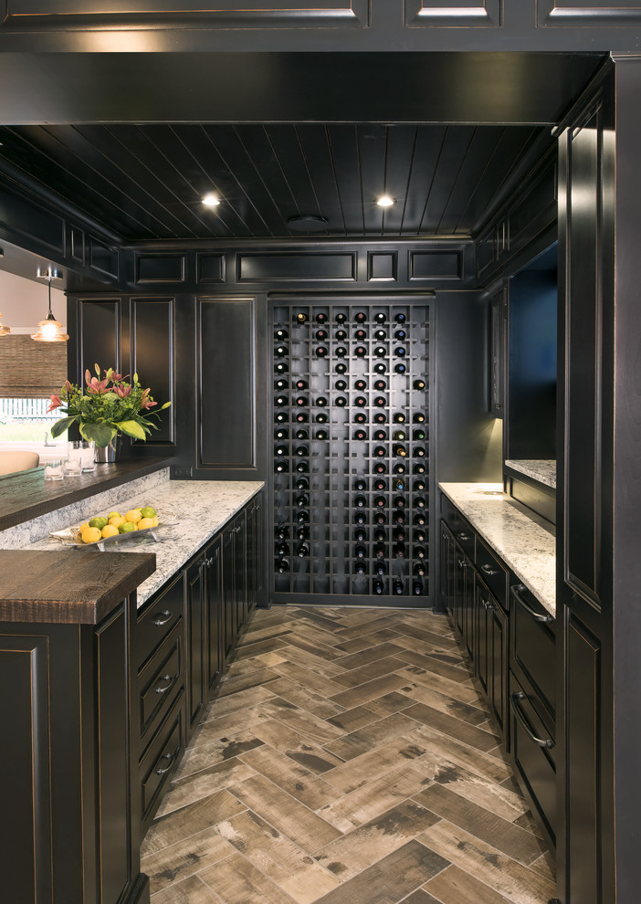 Example of a large transitional u-shaped medium tone wood floor home bar design in Minneapolis with an undermount sink, raised-panel cabinets, black cabinets, wood countertops and multicolored backsplash