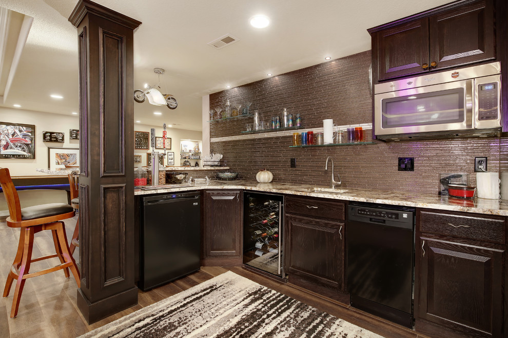 Home bar photo in Denver with an undermount sink, recessed-panel cabinets, dark wood cabinets, granite countertops, beige backsplash and glass tile backsplash