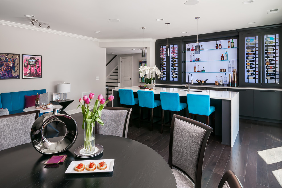 Design ideas for an expansive modern galley breakfast bar with a submerged sink, flat-panel cabinets, black cabinets, engineered stone countertops, dark hardwood flooring, brown floors, blue worktops and glass sheet splashback.