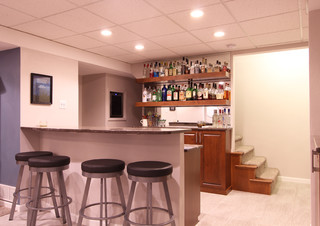 Basement with Medium Stained Cabinets and Floating Shelves ...