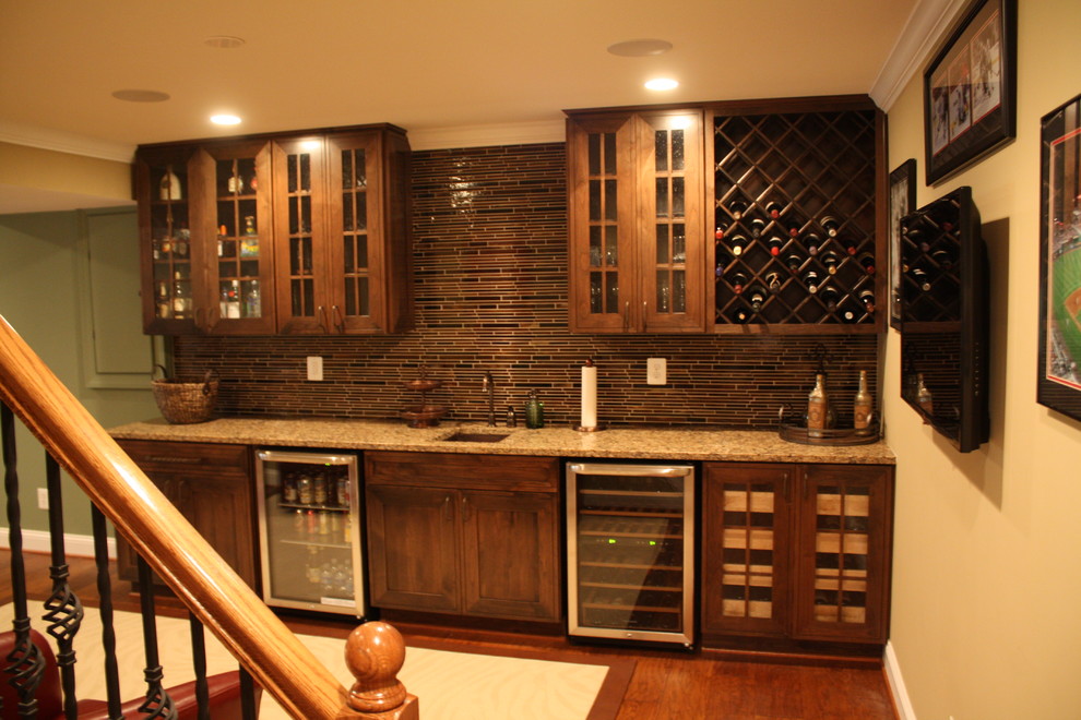 Inspiration for a huge timeless medium tone wood floor and brown floor wet bar remodel in DC Metro with an undermount sink, flat-panel cabinets, dark wood cabinets, granite countertops, brown backsplash and glass tile backsplash