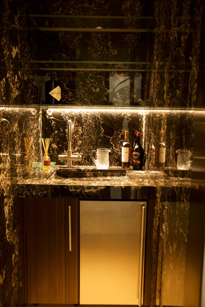 Design ideas for a small contemporary single-wall wet bar in New York with a submerged sink, flat-panel cabinets, dark wood cabinets, granite worktops, multi-coloured splashback and stone slab splashback.