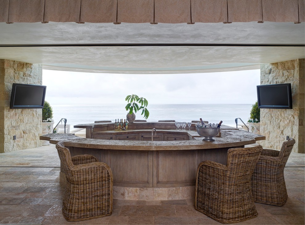 Example of a tuscan u-shaped seated home bar design in Orange County with recessed-panel cabinets and medium tone wood cabinets